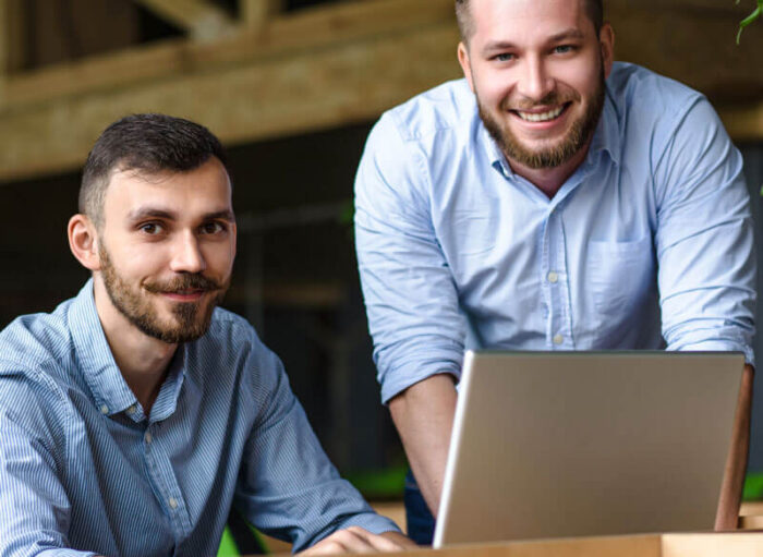 picture-handsome-businessman-listening-his-colleague-partner-concerning-ner-business-system-while-working-laptop-computer-office-interior picture-handsome-businessman-listening-his-colleague-partner-concerning-ner-business-system-while-working-laptop-computer-office-interior